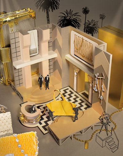 Scattered around a paper model of an old hollywood hotel set are high-end luxury gifts and accessories