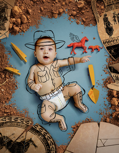 A baby is dressed as an archaeologist, and surrounded by tools and ancient artifacts 